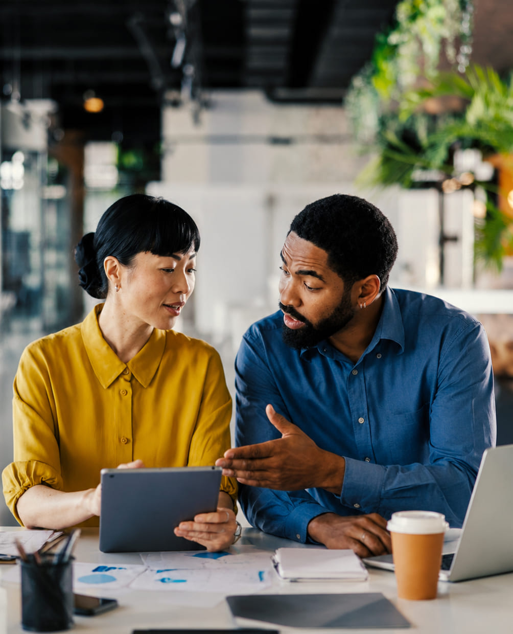Two colleagues reviewing a campaign plan on a tablet